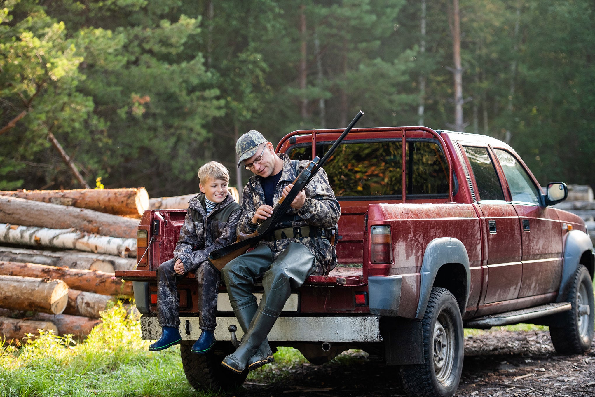 Father and son hunting, talking about proper food plot management